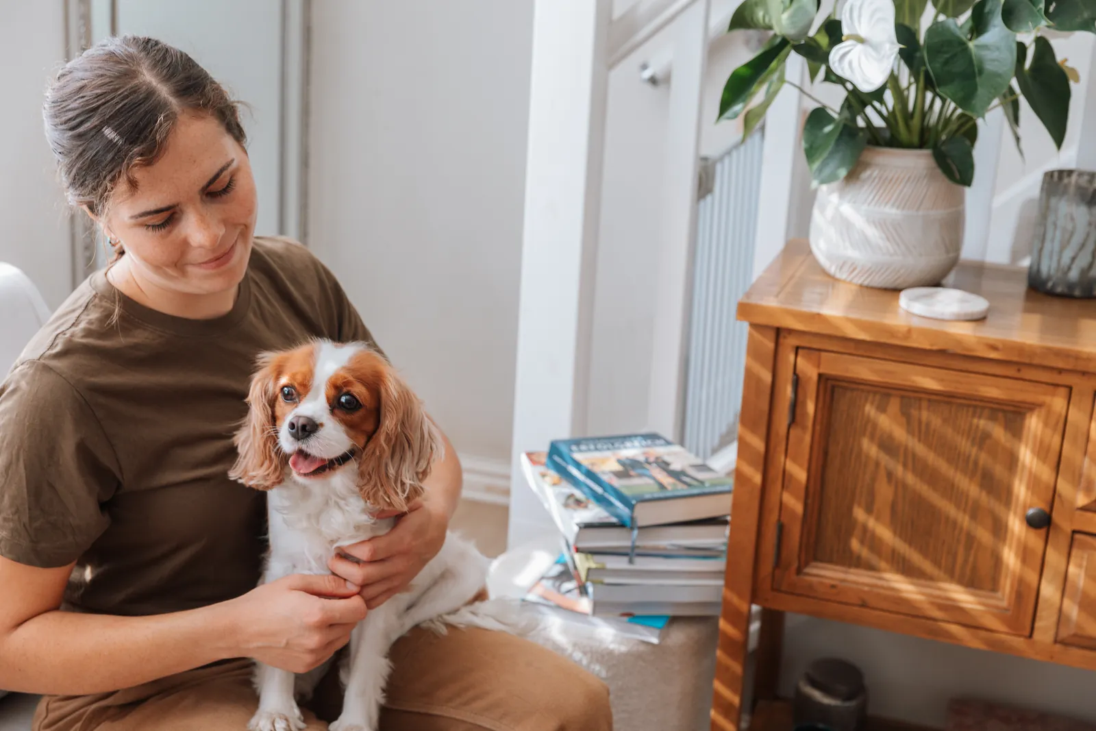 Flurina at home with a spaniel on her lap