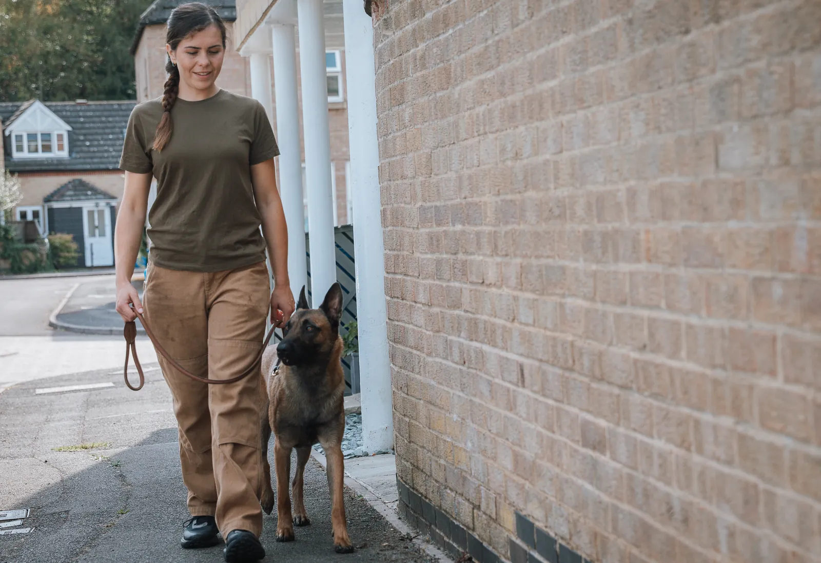 Flurina walking a dog on a loose lead along a pavement